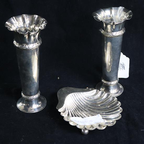 A pair of Edwardian silver spill vases and a silver shell butter dish.